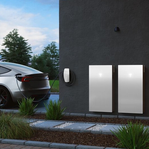 Tesla Wall Connector and Tesla Powerwall 3 pictured with a Tesla Model 3 car nearby